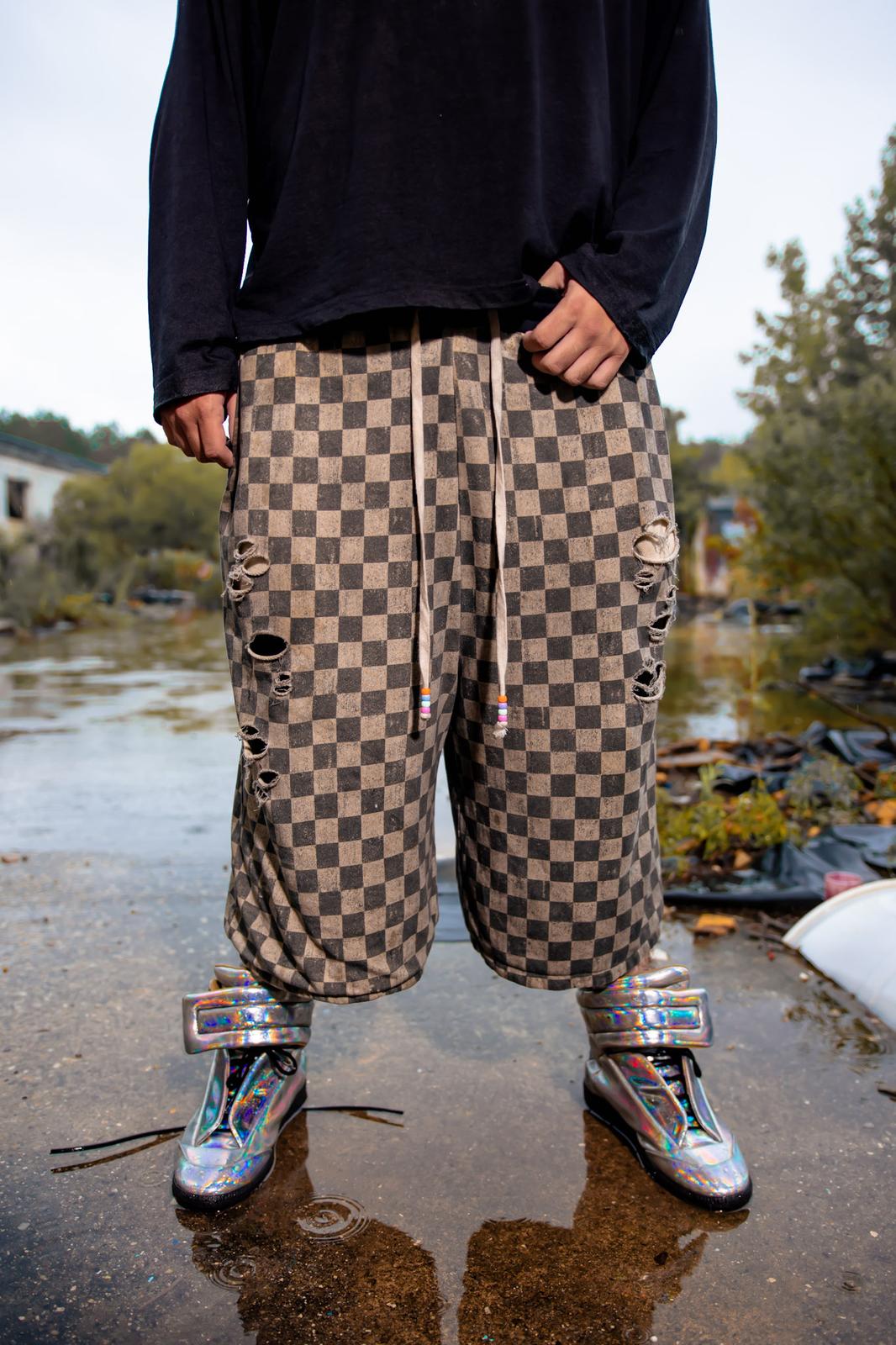 Kollectixe Drop 03 — Checkmate checkerboard shorts worn on location