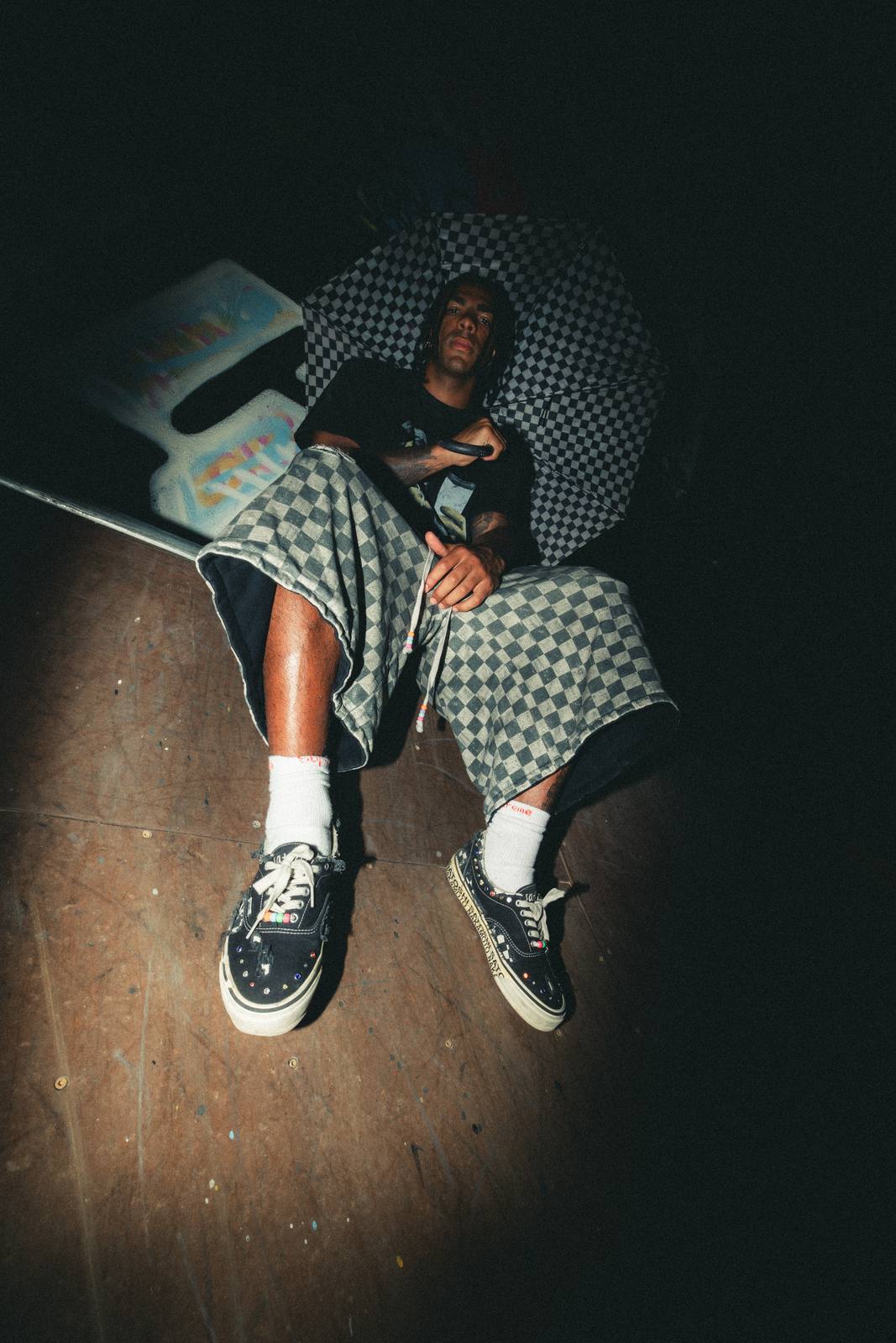 Kollectixe S/F26 — checkerboard hood and shorts, shot at night on a skate ramp